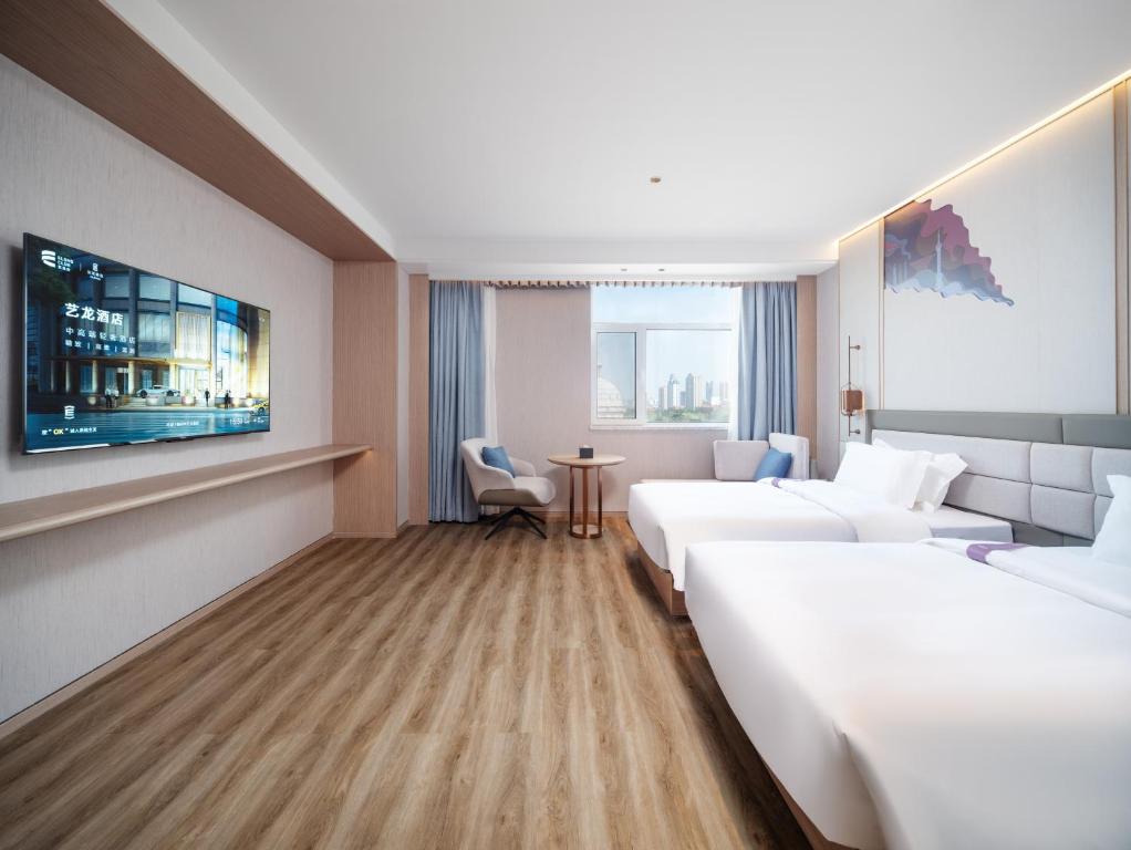 Postel nebo postele na pokoji v ubytování Elong Hotel City Hall Branch