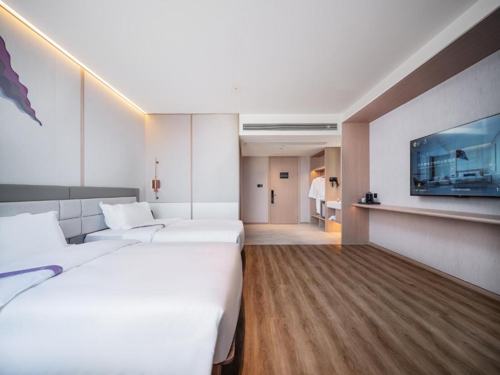 Postel nebo postele na pokoji v ubytování Elong Hotel City Hall Branch