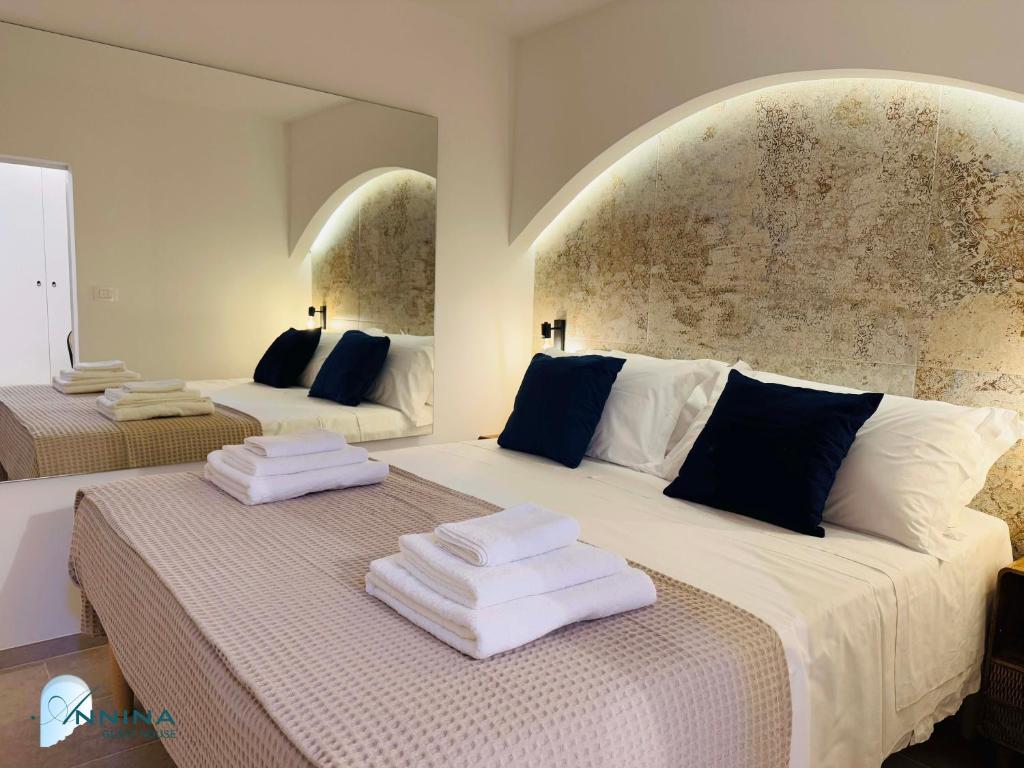 a bedroom with two beds with towels on them at Annina guest house soggiorno vista mare in Savelletri di Fasano