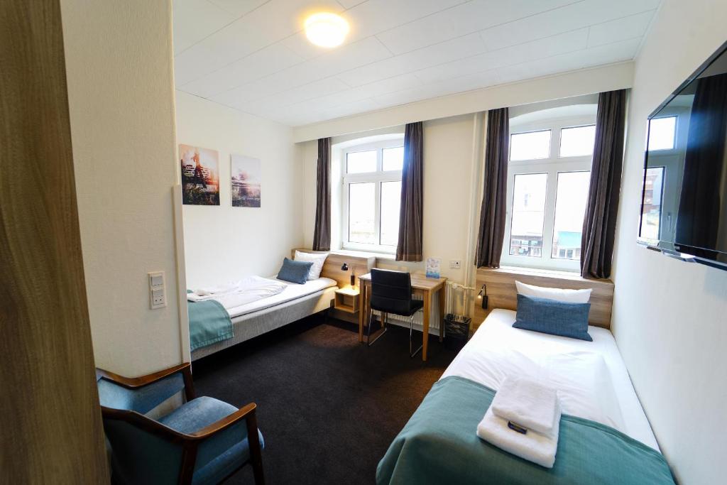 Postel nebo postele na pokoji v ubytování Hotel Ansgar
