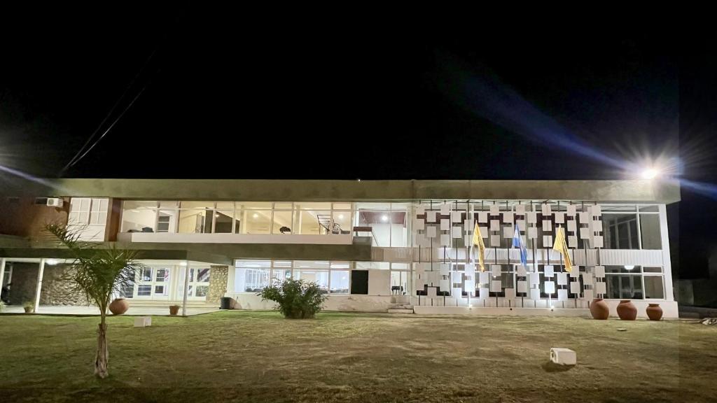 a building with a lot of windows at night at Hotel ACA Chilecito in Chilecito