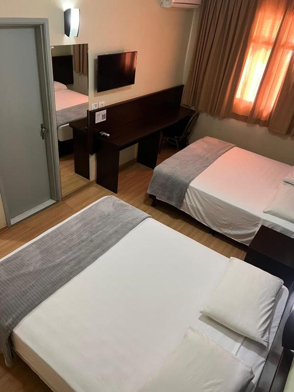 Postel nebo postele na pokoji v ubytování Dom Pedro I Palace Hotel