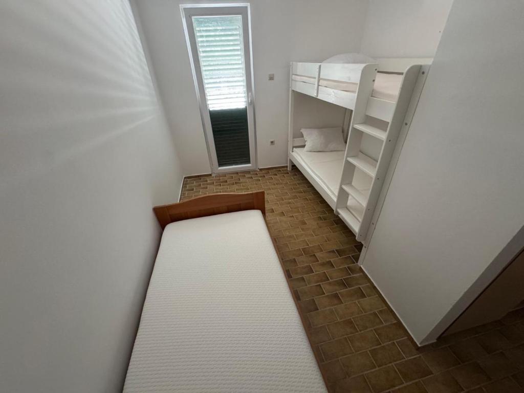 Postel nebo postele na pokoji v ubytování Apartments Prosika