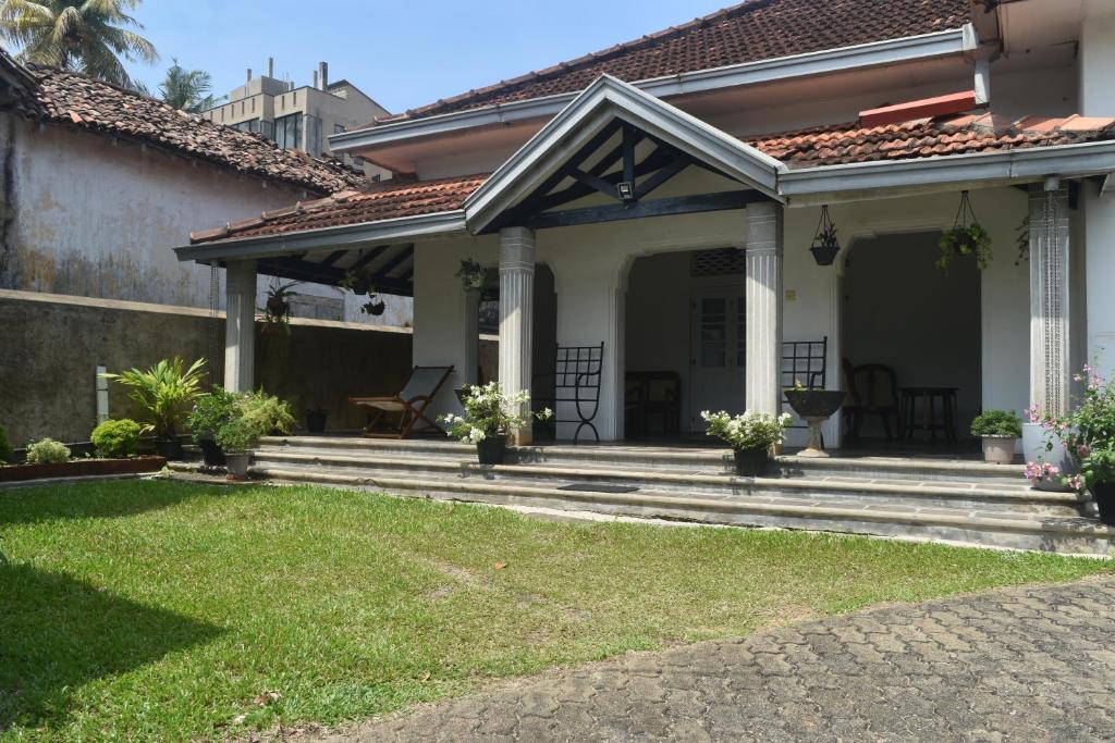 a house with a porch with a patio at Mahagedara in Galle
