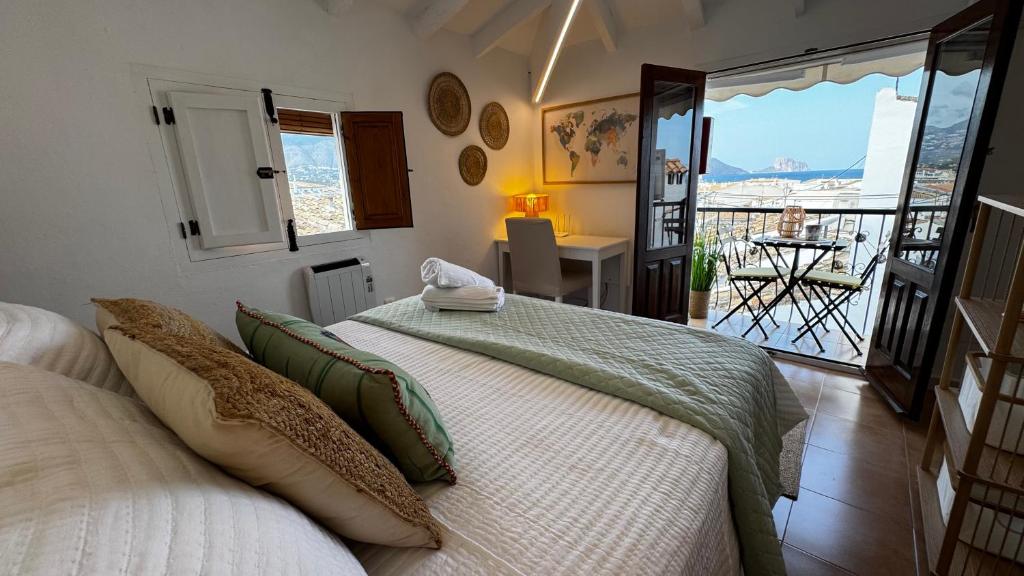 a bedroom with a bed and a view of a balcony at Harmonia De La Mar in Altea