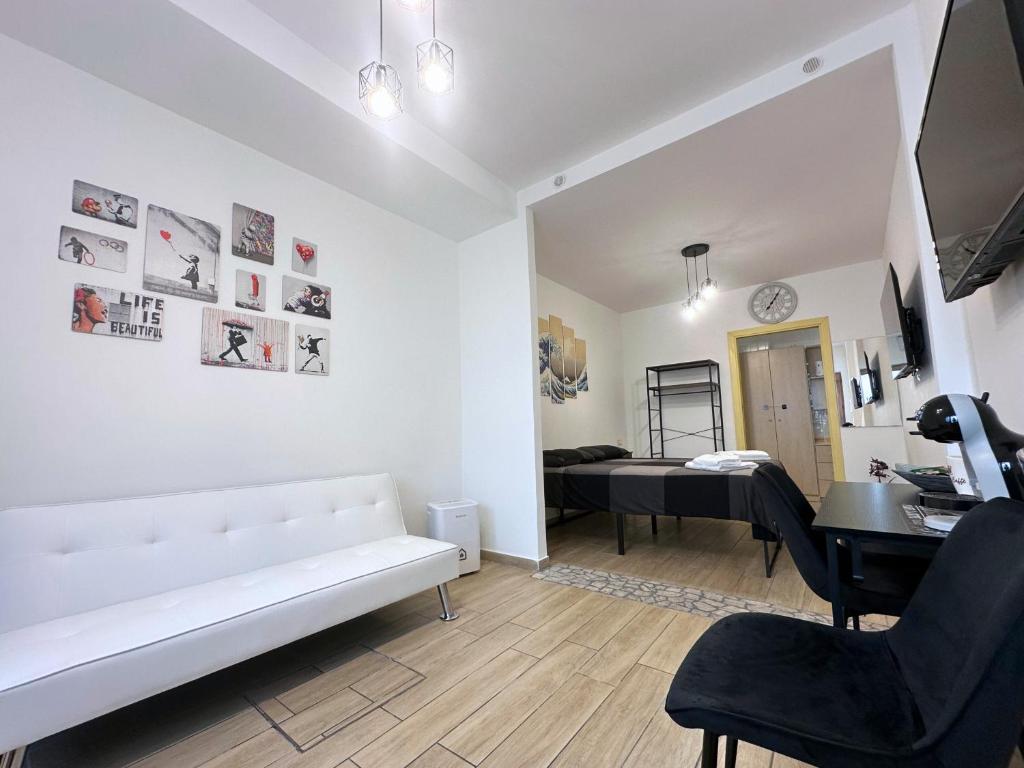 a living room with a white couch and a table at Annarè House in Ischia