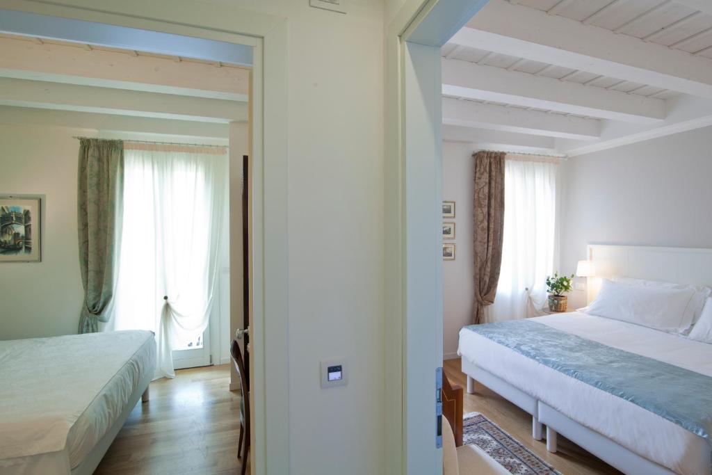 Postel nebo postele na pokoji v ubytování Chiara - Lodge