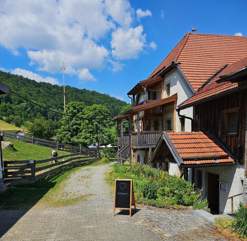 a building with a sign in front of it at Ferienwohnung "Kräuterhof" in Ringelai