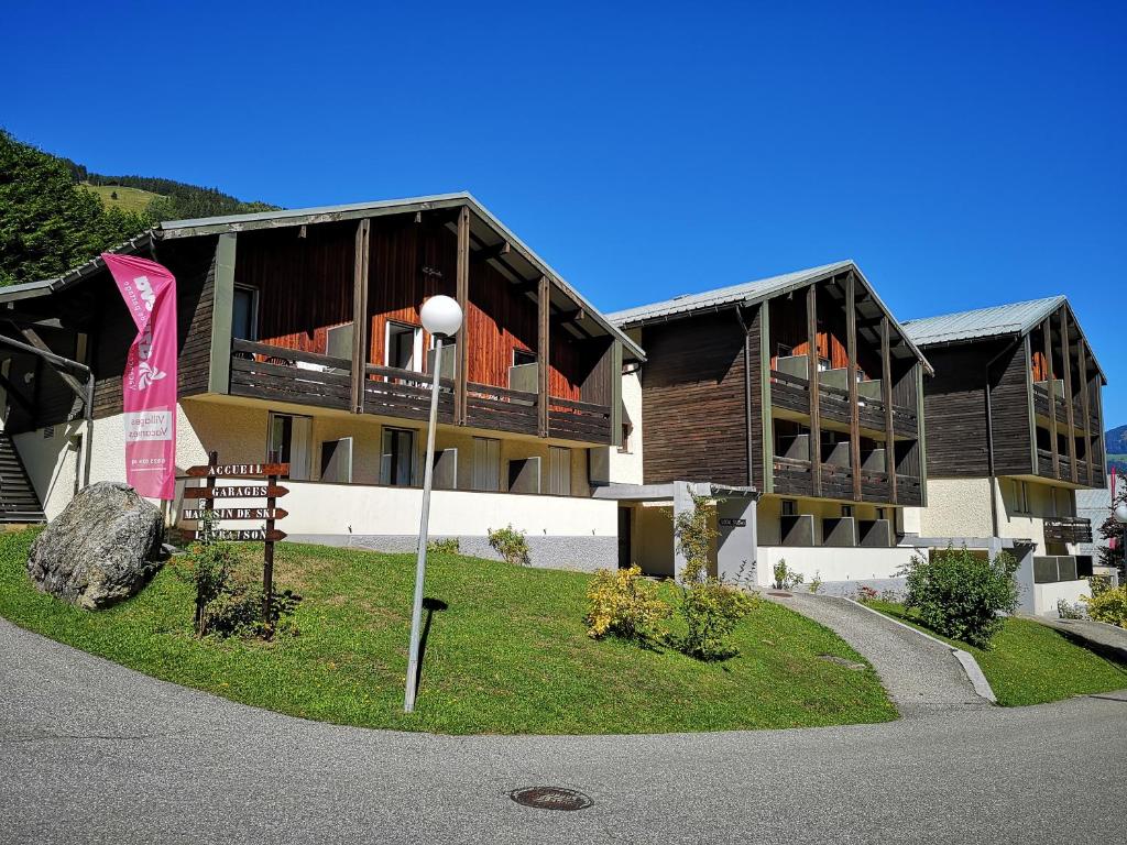 a building with a flag in front of it at Azureva Club Arêches in Arêches-Beaufort