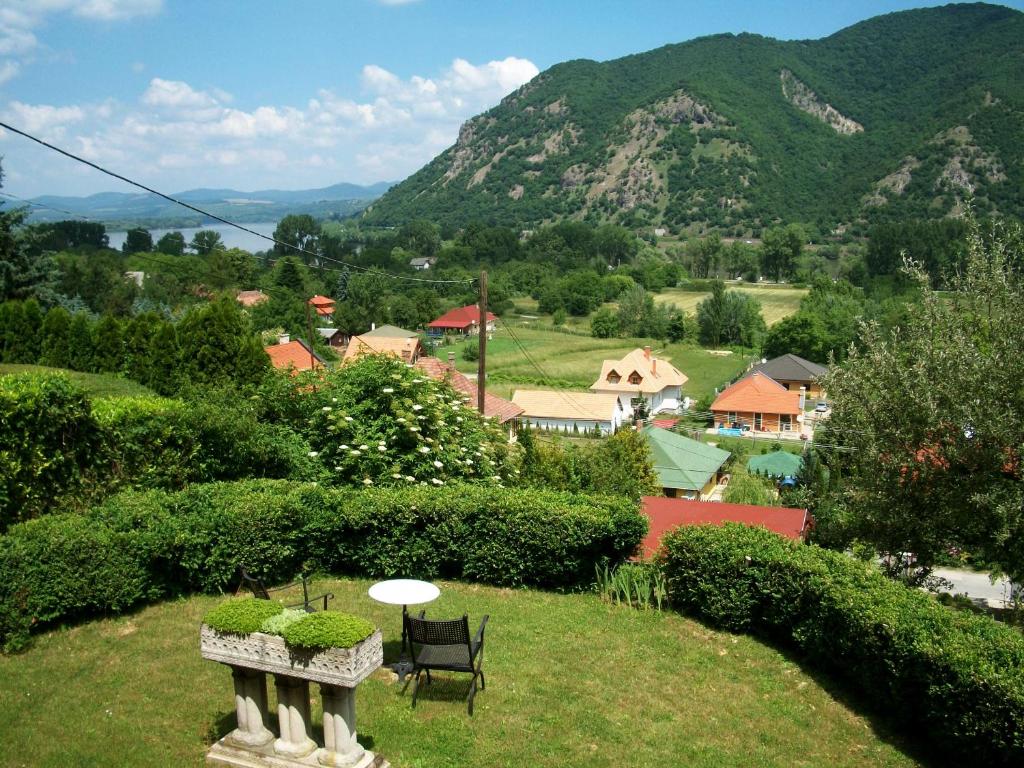 a garden with a view of a town and mountains at Villa Panorama Artist in Dömös