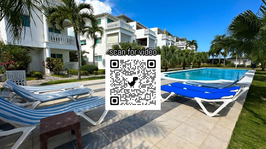 a pair of lounge chairs next to a swimming pool at La Fenice Beachfront 3 Bedroom With Parking in Las Terrenas