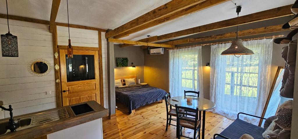 a bedroom with a bed and a table in a room at Kempings Liepene in Liepene