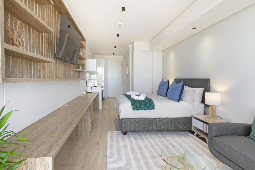 a living room with a bed and a couch at Ellipse Waterfall 3802 in Midrand