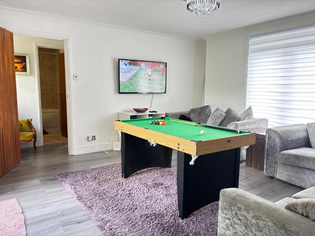 a living room with a pool table in it at Large 2BR Bungalow Independent fully Furnished with Parking & Garden in Bradenham