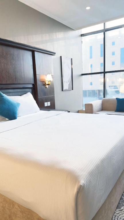 Postel nebo postele na pokoji v ubytování اجنحة الطائف للشقق المخدومة - Al Taif Suites