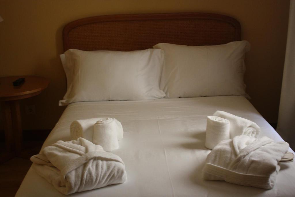 Postel nebo postele na pokoji v ubytování Hotel Toural