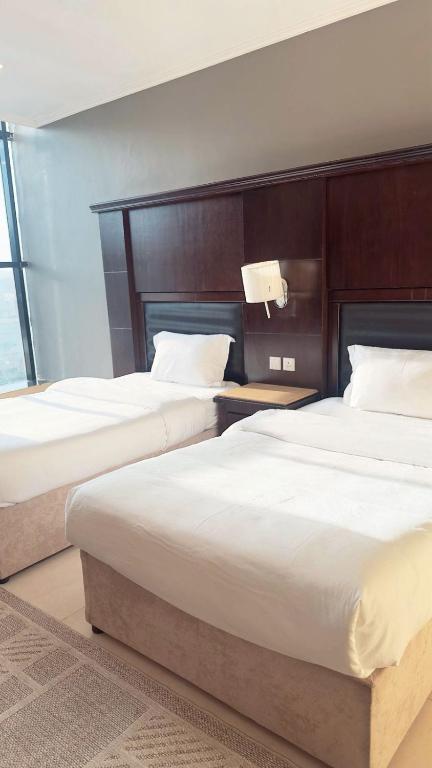 Postel nebo postele na pokoji v ubytování اجنحة الطائف للشقق المخدومة - Al Taif Suites