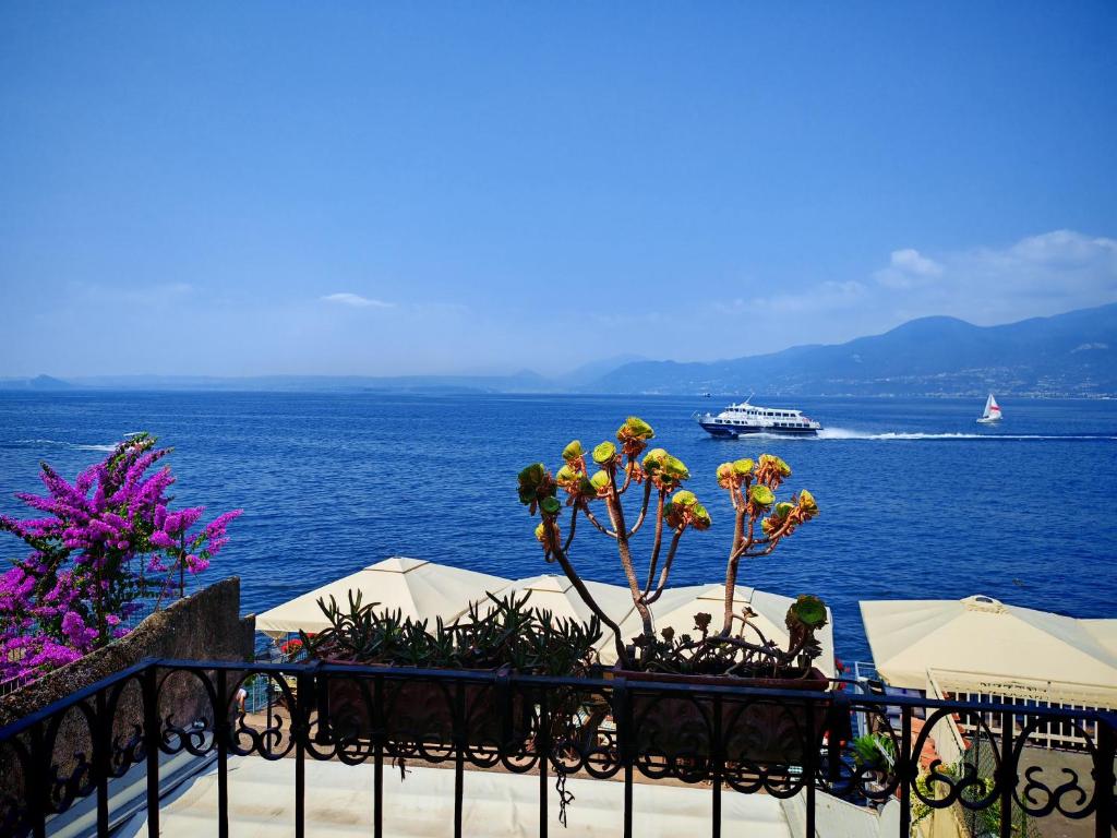 a view of the ocean with a cruise ship in the distance at SG Luxury - Pieds dans l eau Torri in Torri del Benaco