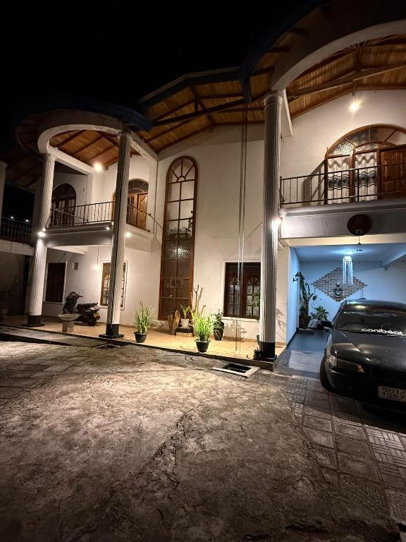 a car parked in front of a house at night at Villa Suriya in Tennekumbura