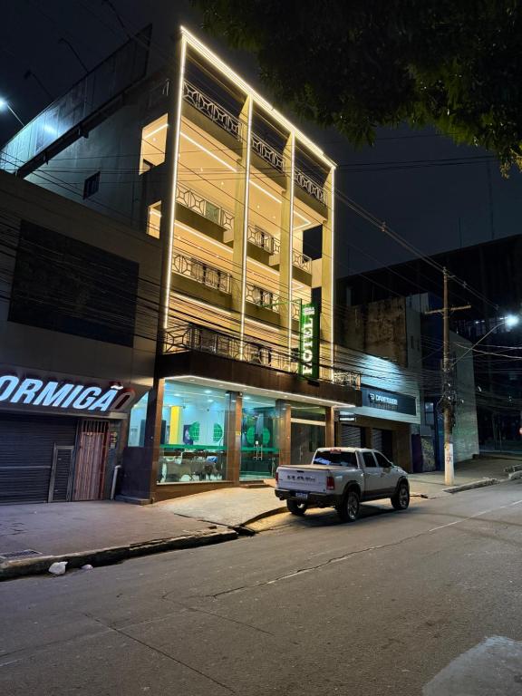 a truck parked in front of a building at night at Terra Verde Hotel in Rio Branco