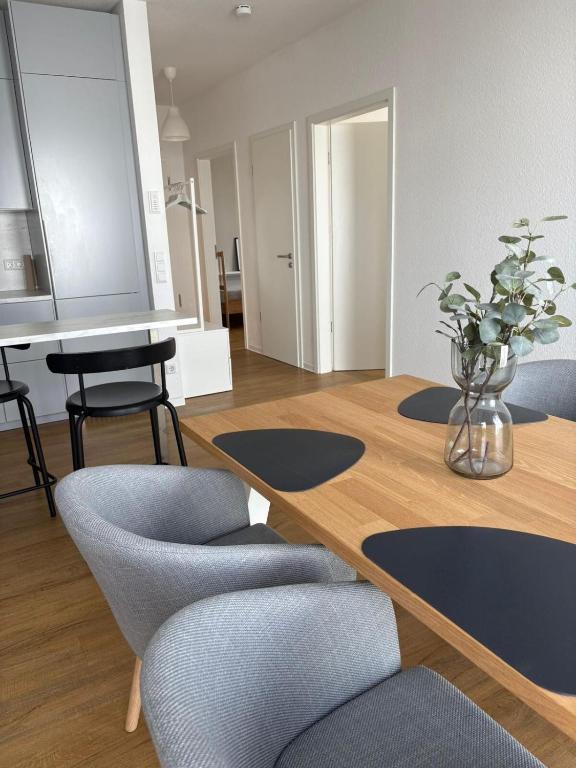 a dining room with a wooden table and chairs at Penthouse Apartment in Gießen
