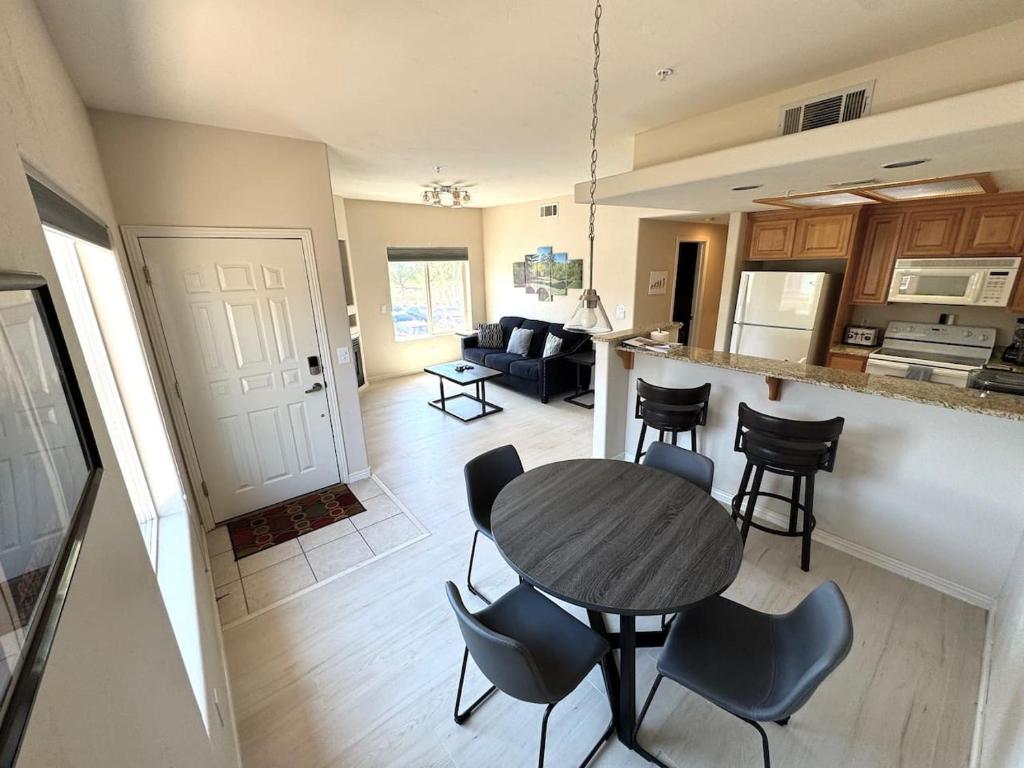 a kitchen and living room with a table and chairs at Condo on Wolf Creek Golf Course in Mesquite