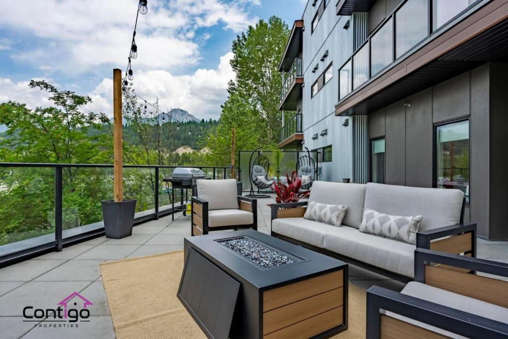 a patio with a couch and a table on a balcony at Decked Out, Mtn Views, AC, Big Patio, DT, BBQ in Golden