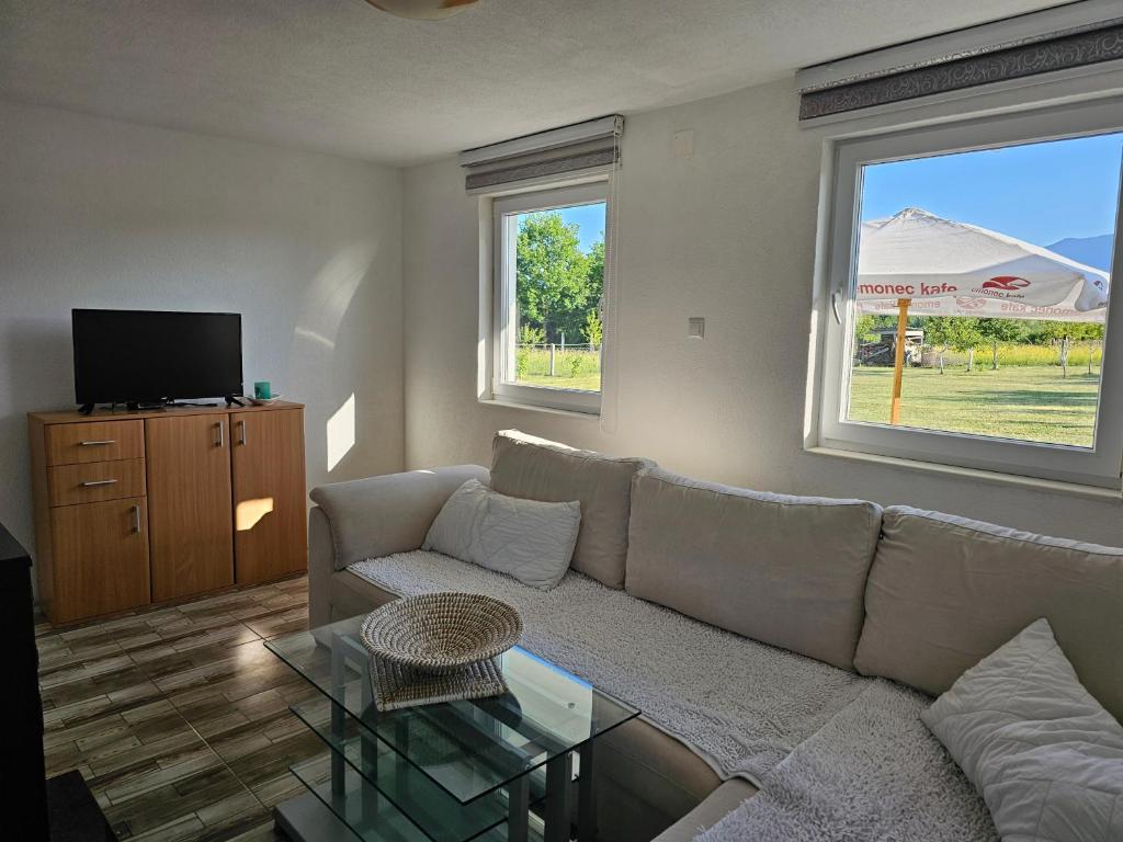 a living room with a couch and a tv at Villa Melek in Bihać