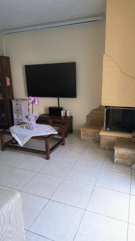 a living room with a large flat screen tv at John & Mary's House Kalivia Near Sea & Athens Airport in Kalívia Thorikoú
