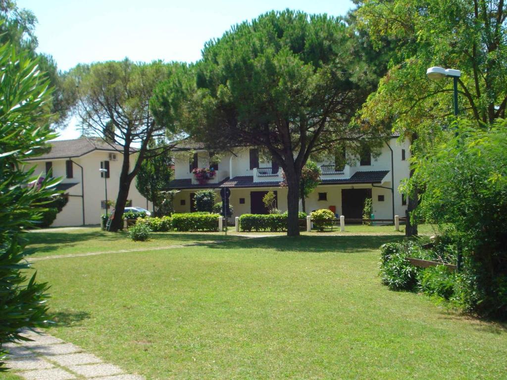 a large white house with trees in a yard at Holiday Homes in Porto Santa Margherita 24674 in Porto Santa Margherita di Caorle