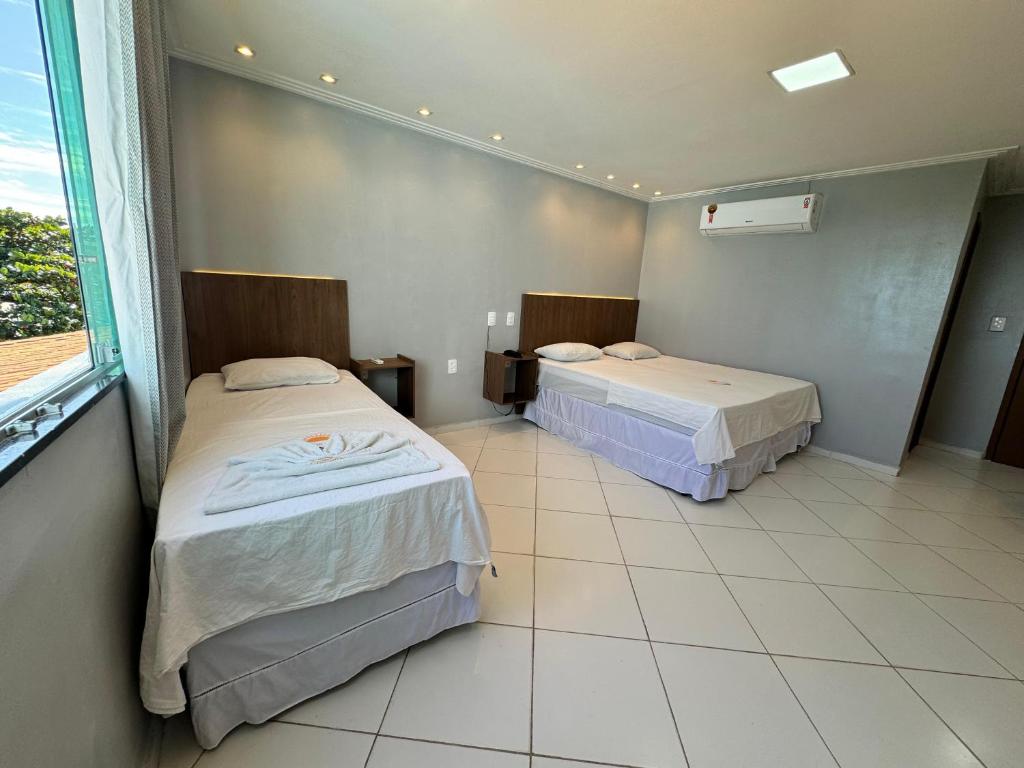 Postel nebo postele na pokoji v ubytování Hotel Luar de Itapua