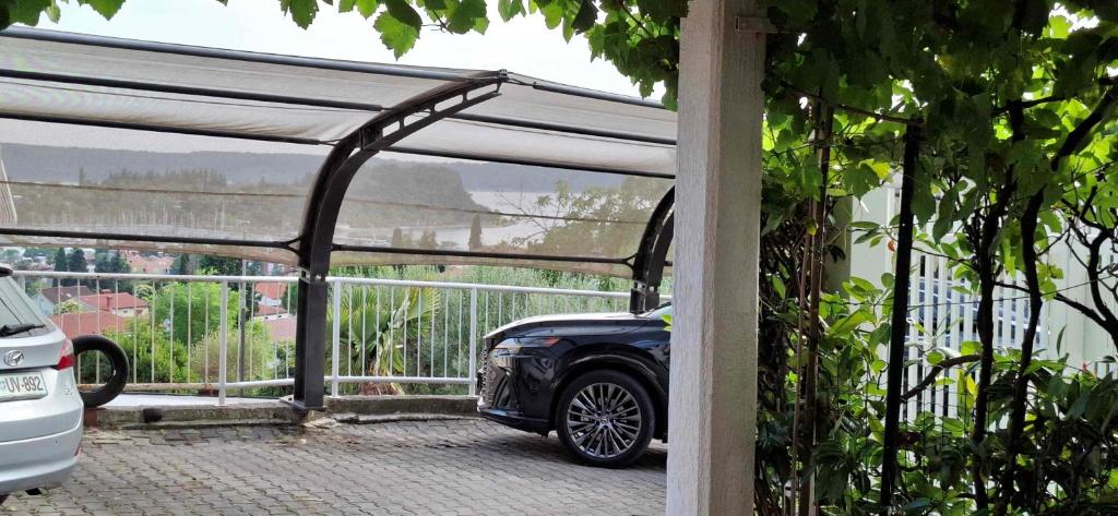 a car garage with a car parked under a canopy at Mike1890 in Portorož