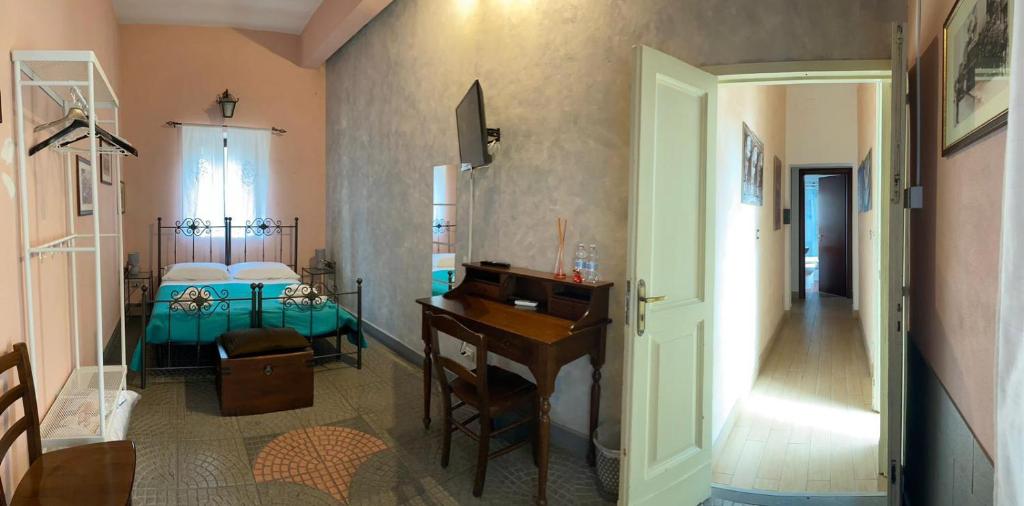a room with a desk and a bedroom with a bed at Catania city center appartaments in Catania