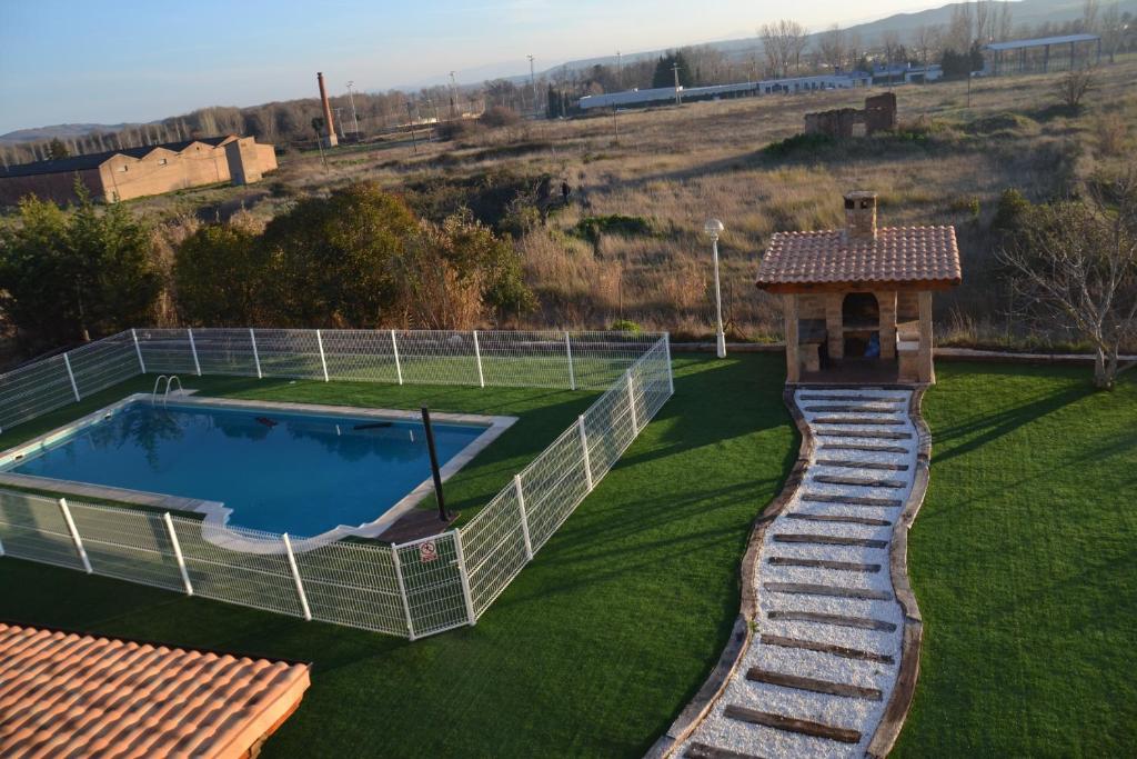 a swimming pool in a field with a gazebo at Villalodosa in Lodosa