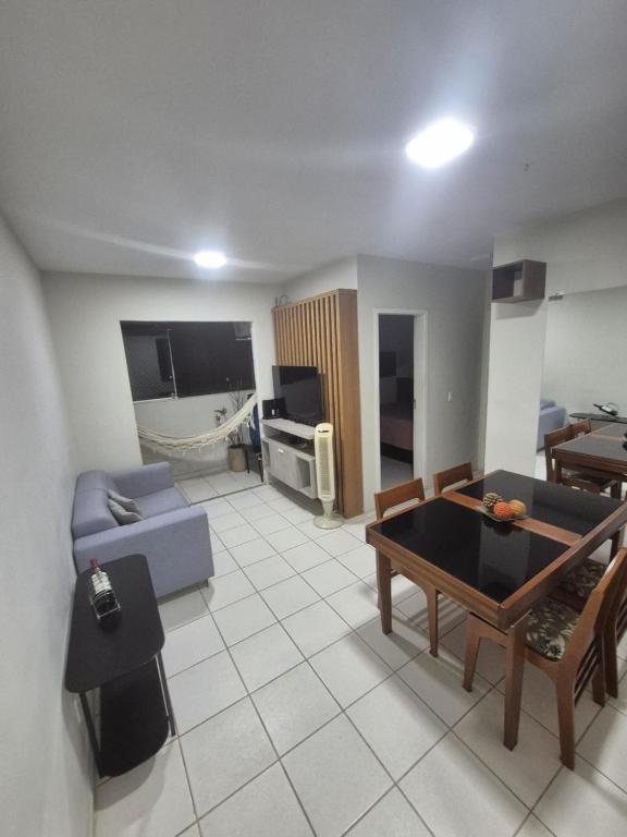 a living room with a couch and a table at Apartamento aconchegante e bem localizado in Belo Horizonte