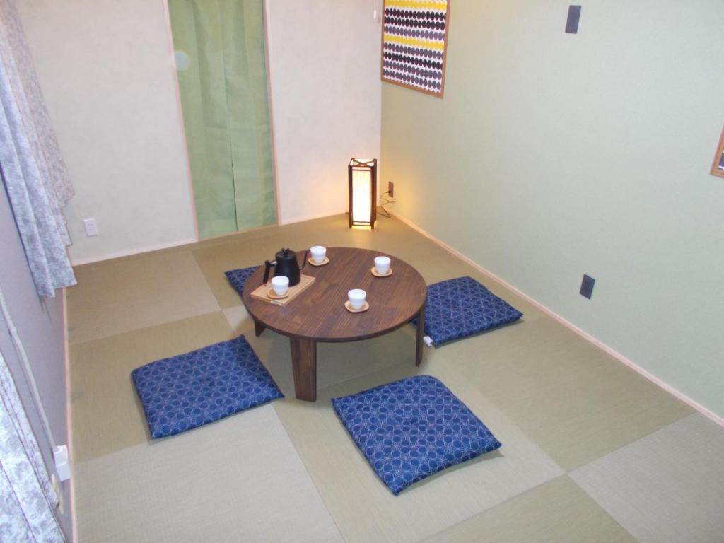 a room with a wooden table and blue chairs at CS Asakusa Building 2nd floor - Vacation STAY 95354v in Tokyo