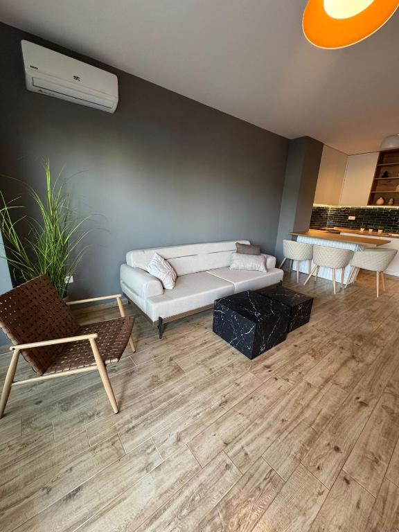a living room with a white couch and chairs at AD Luxe Lake Suite in Ohrid