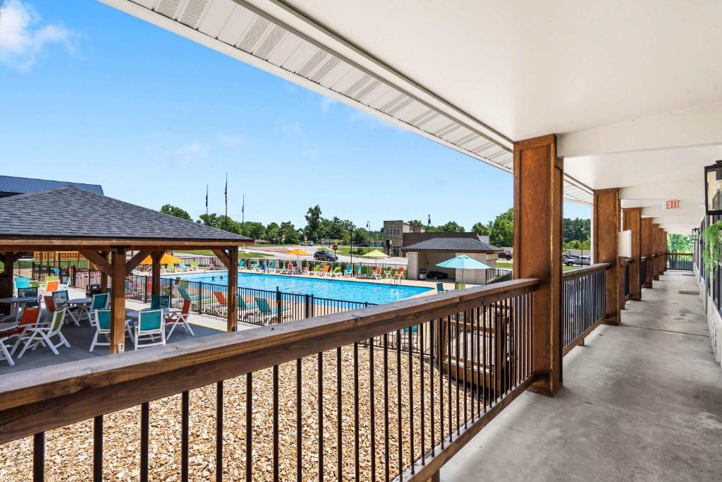 an indoor balcony with a pool and patio furniture at Poolside Near the Landing For 2 in Branson