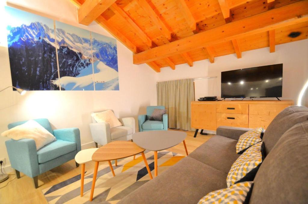 a living room with a couch and chairs and a tv at Chalet Barthelemy - Petit cocon authentique dans les 3 vallées MAE-4204 in Saint-Martin-de-Belleville