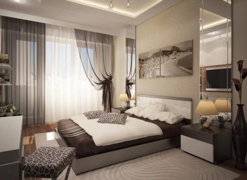 a bedroom with a large bed and a window at Pleasure Apartment near center of Odessa in Odesa