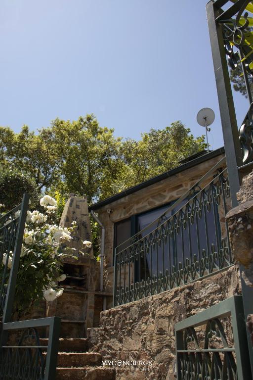 a set of stairs leading up to a house with a balcony at Casa do Passadiço in Espiunca