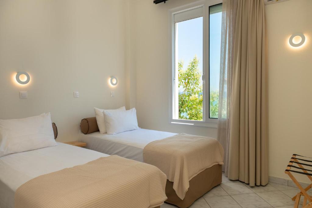 Postel nebo postele na pokoji v ubytování Ellinas Hotel