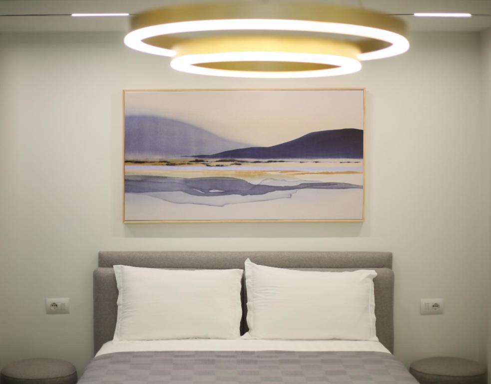 a bedroom with a bed with a large ceiling at Gledors Luxury Apartments in Vlorë