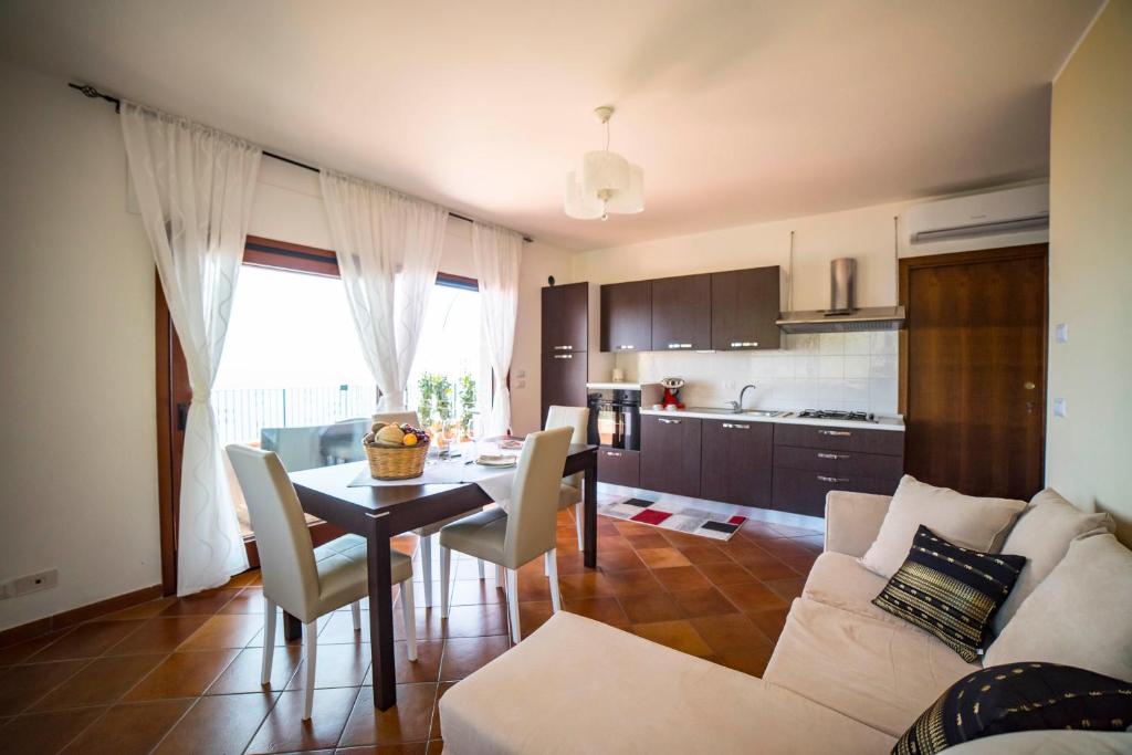 a living room with a white couch and a table at Villa Sofia in Taormina