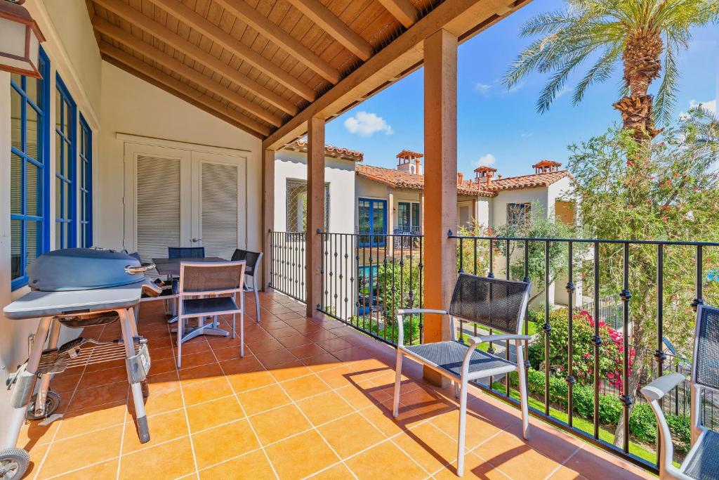 a patio with a table and chairs on a balcony at LV368 Upstairs 3BR LV Condo with 2 Primary Suites in La Quinta