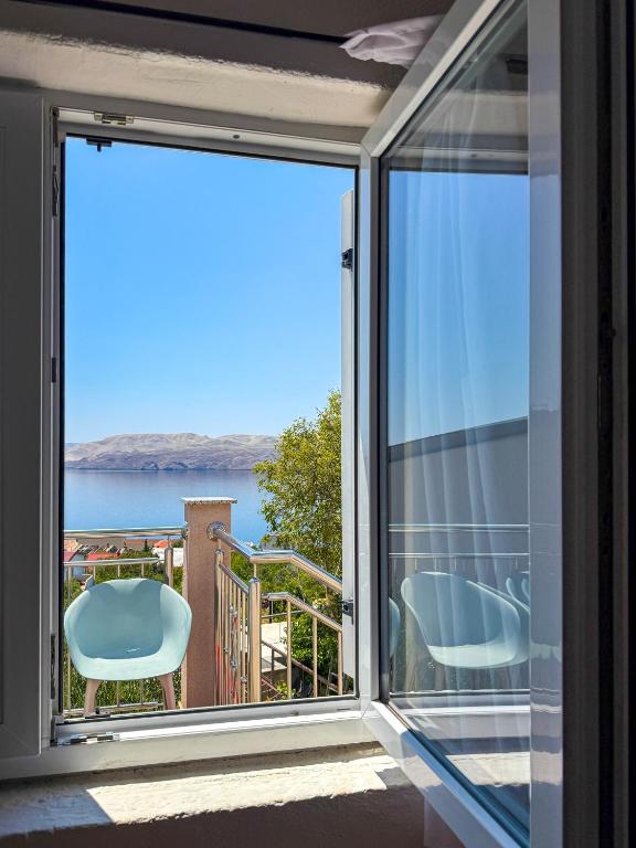 a sliding glass door with a view of the ocean at Lantana ex Villa Americana in Karlobag