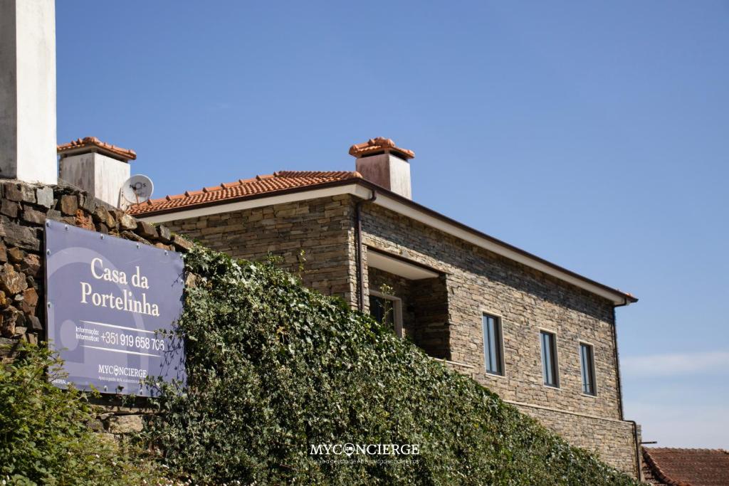 a building with a sign on the side of it at Casa da Portelinha in Castelo de Paiva