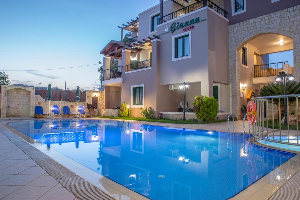 a swimming pool in front of a building at Gianna Apartments in Almyrida