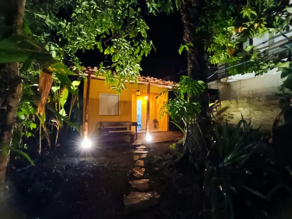 a house in the middle of a forest at night at Casa Canto Verde in Itacaré