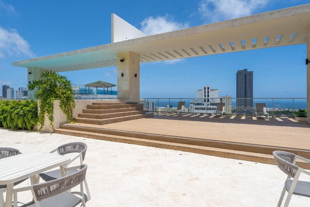 a view from the roof of a building with tables and chairs at JR 7 Suites by Yellowkey in Santo Domingo
